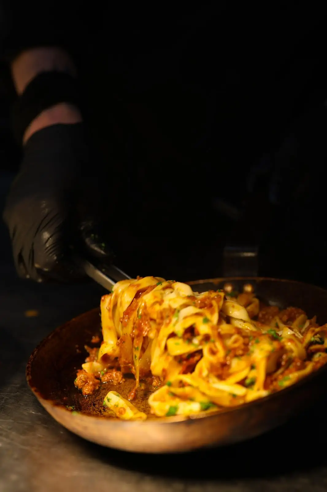 Chef making fresh tagliatelle by hand