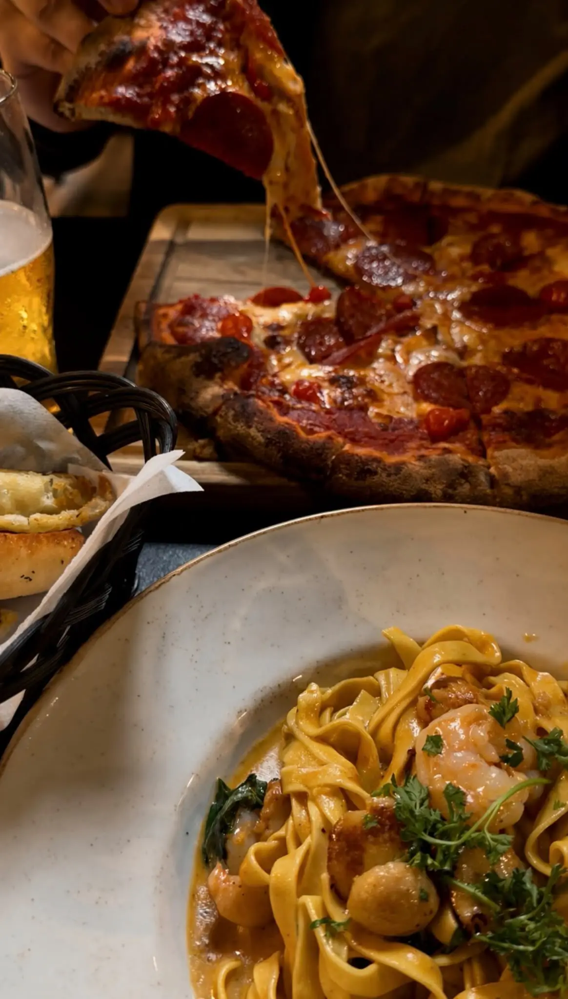 Freshly baked pizza and pasta served with drinks at Social Monkey Aberdeen